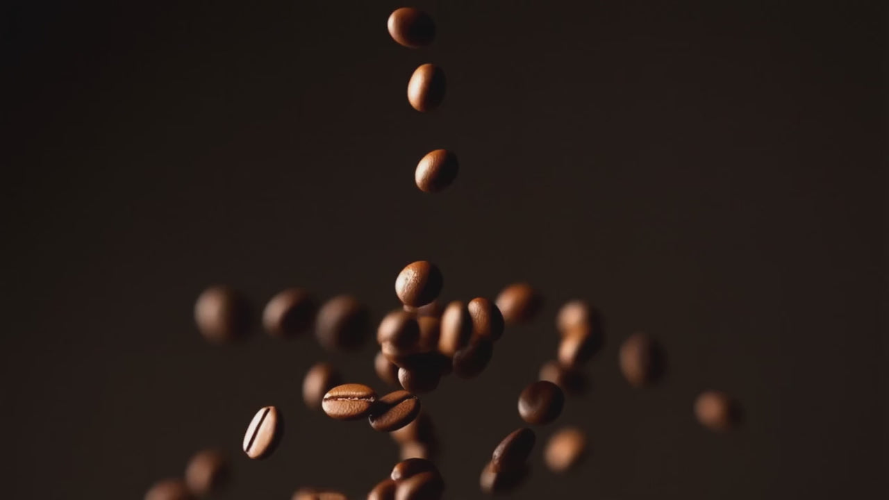Artisanal coffee beans falling into a grinder, coffee brewing process, and woman enjoying a cup of single-origin coffee